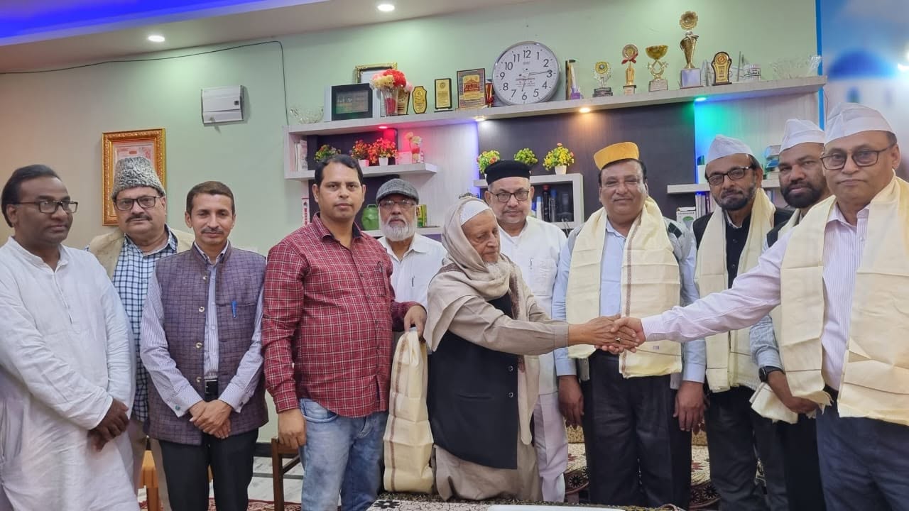 Members of the Trust honouring a senior guest with a shawl at the Darbhanga office