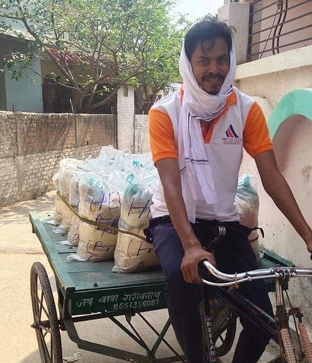 A volunteer delivering sacks of relief rations by handcart during the Trust's flood relief work